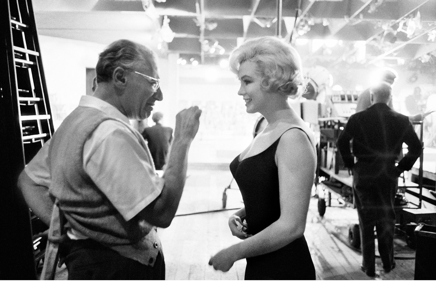 Marilyn Monroe listens to director George Cukor on the set of 
